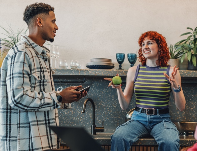 Office workers chatting in break room