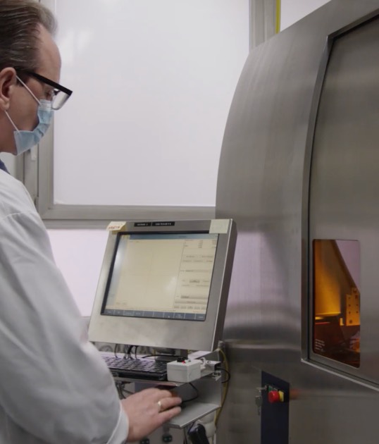 man using machine to study diamond
